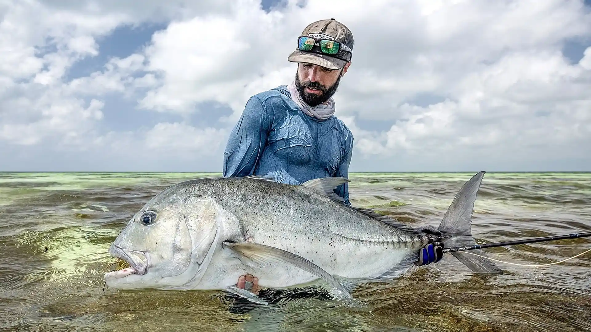 Alphonse Island angler with a large giant trevally while fly fishing.