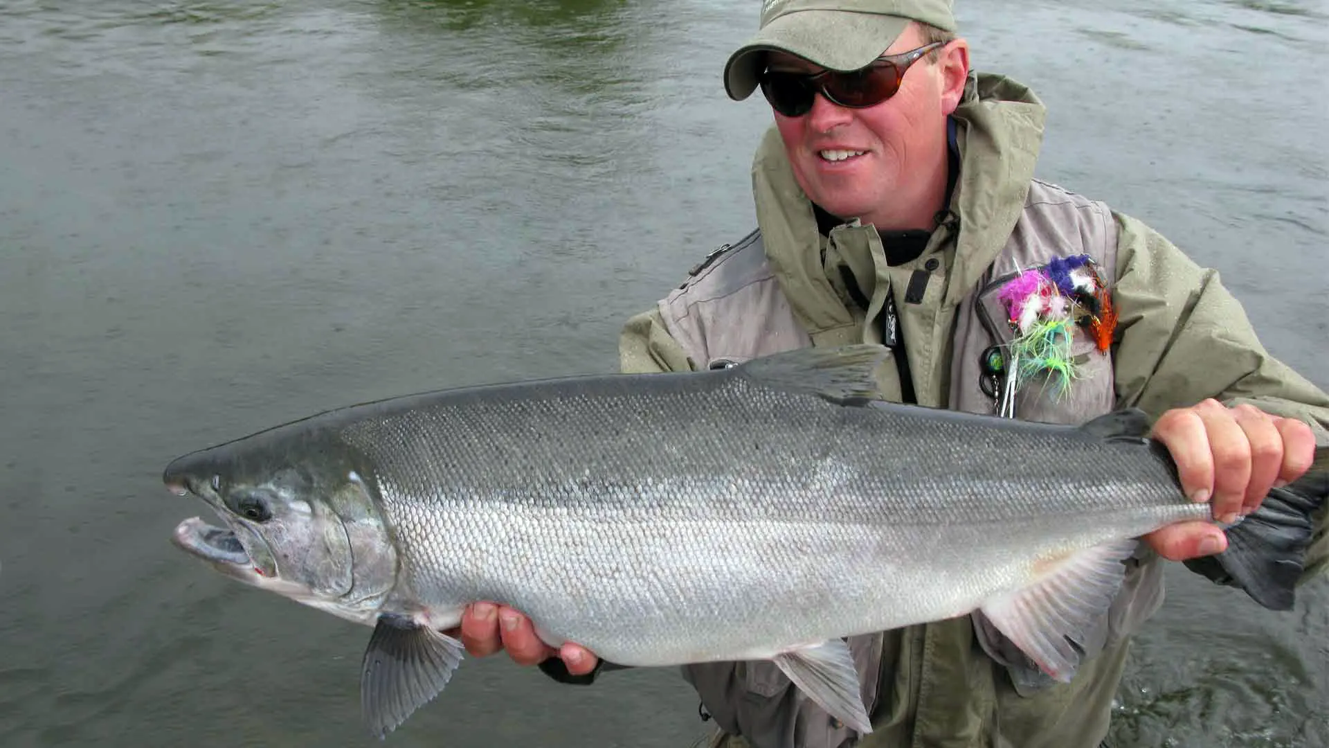 Sapsuk River angler holding large male Coho Salmon in Alaska
