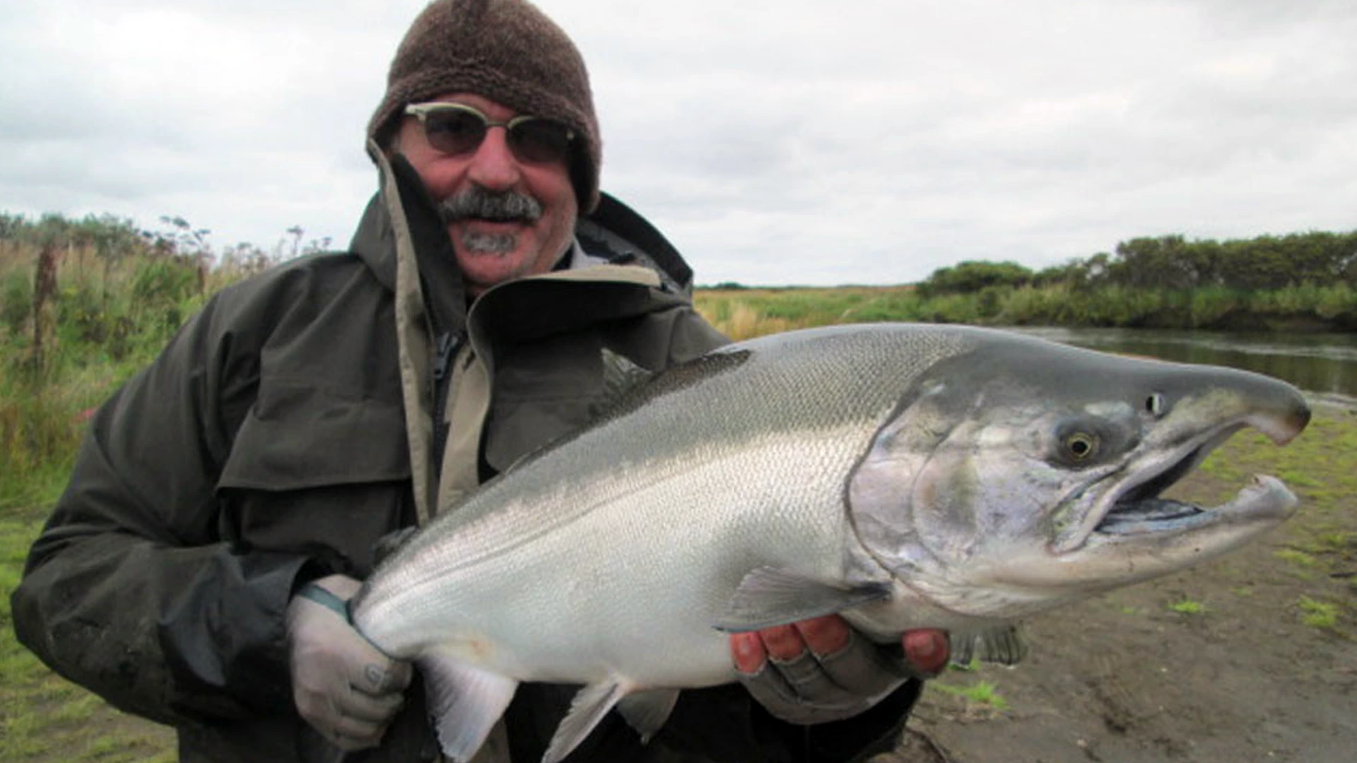 Sapsuk River angler holding large male Coho Salmon in Alaska