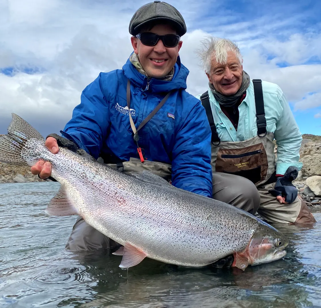 Kirk Chiapella and Giant Rainbow At Jurassic Lake Lodge in Argentina, fishing is three anglers per guide.