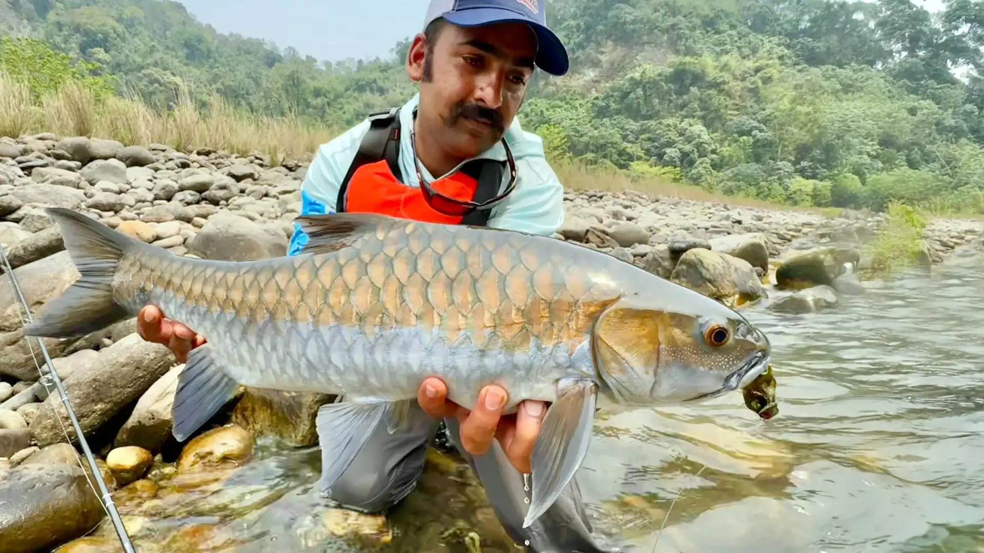 Manas River Lodge guide Bobby Saptal with a Chocolate Mahseer in Bhutan.