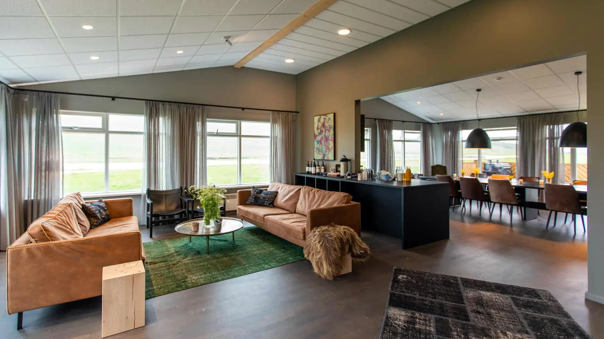 The comfortable great room at Long Valley Lodge in Iceland has river and mountain views.