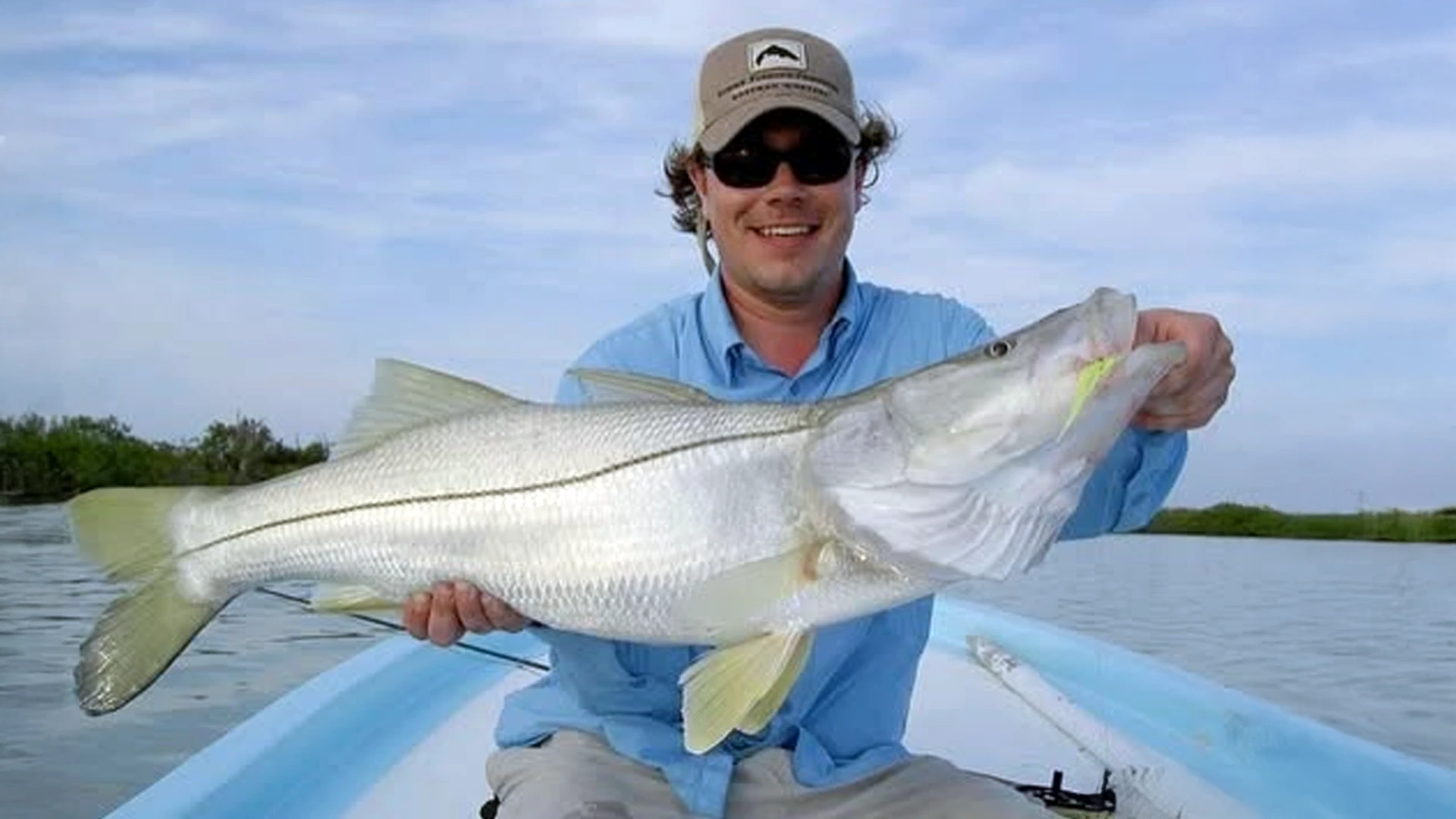 Angler with a large snook - Ascension Bay fishing is famous for Grand Slam and Super Grand Slam potential.