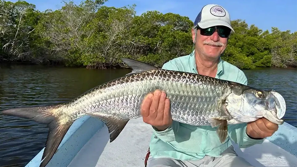 Isla Blanca Flats offers fly or spin fishing for baby and large tarpon and permit with Fin Chasers, with beachfront lodging.
